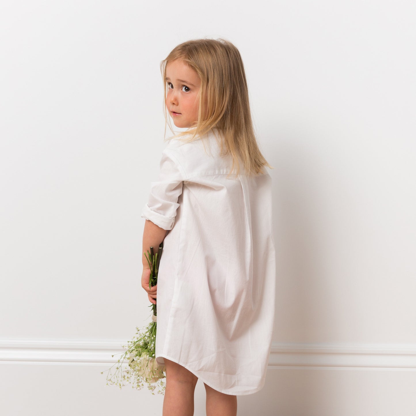 Girl wearing white shirt dress with flowers