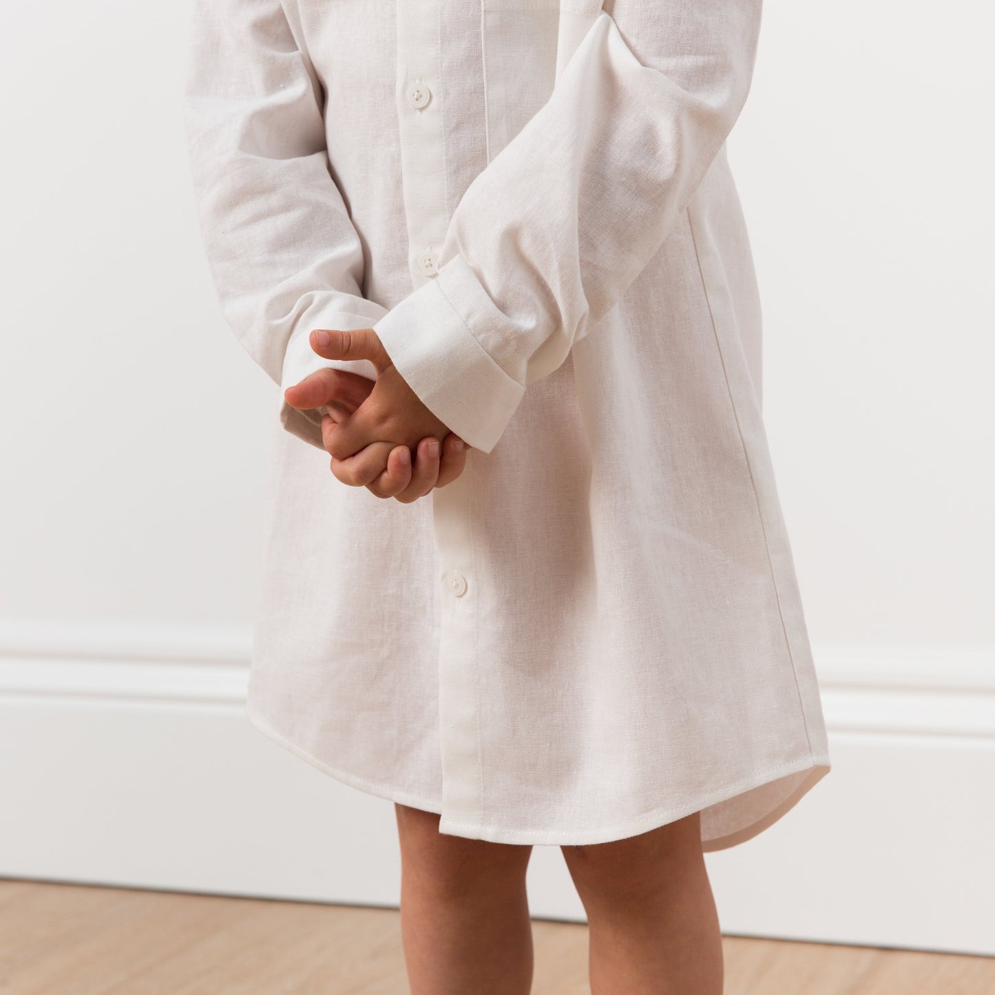 Close up of girl wearing white shirt dress