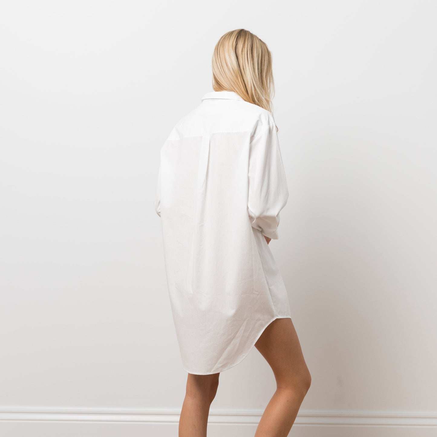 Woman wearing white shirt dress