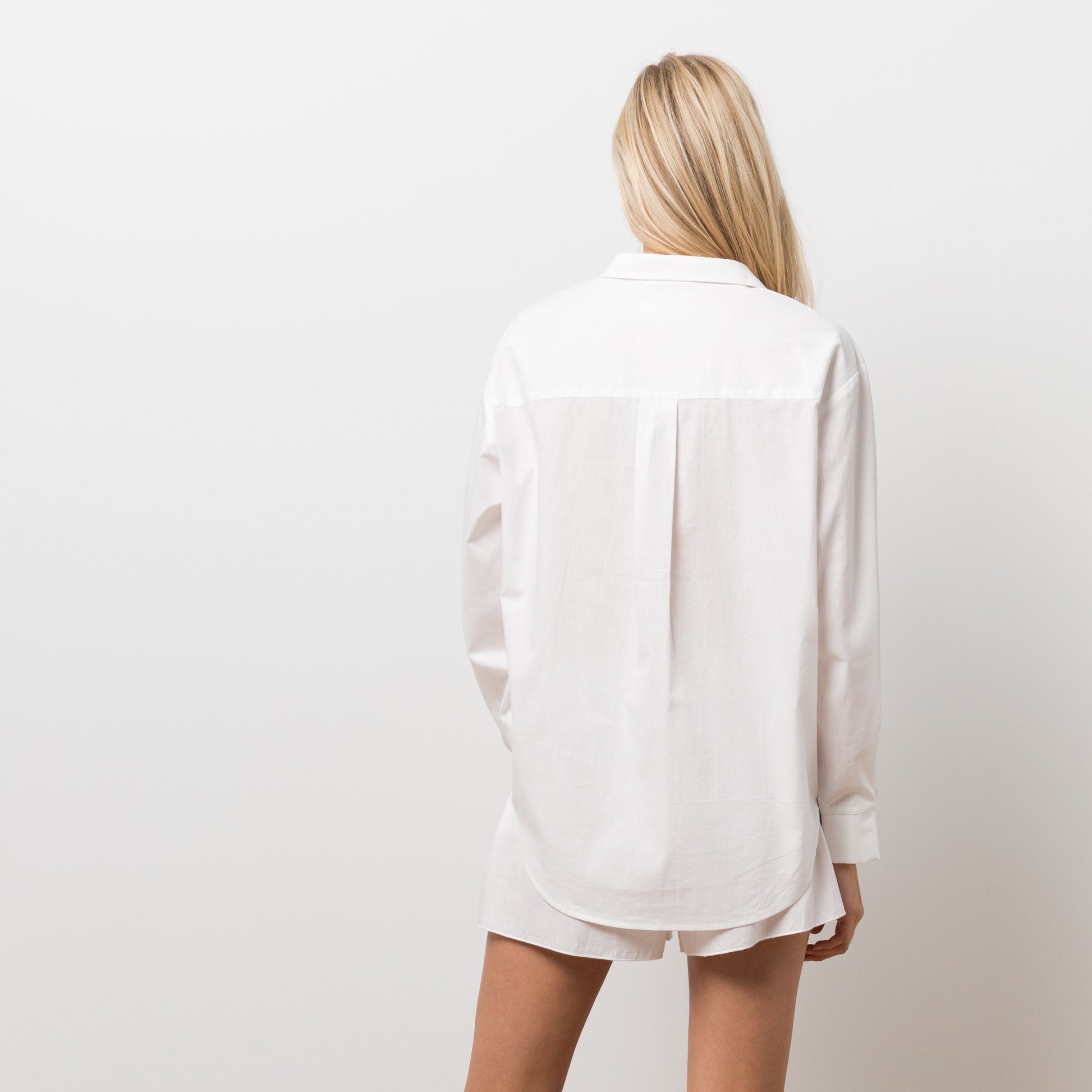 Woman wearing white shirt and shorts