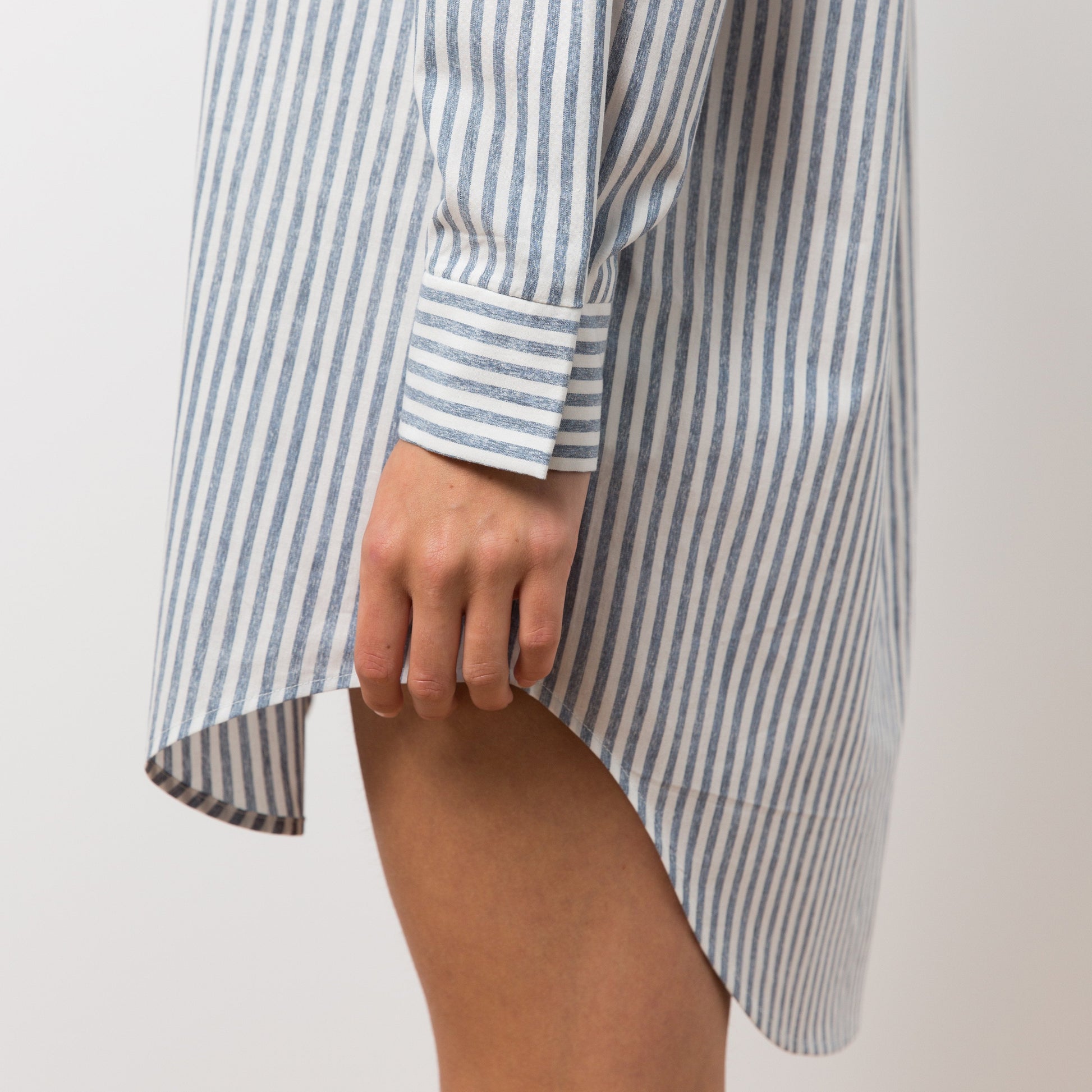 Close up of woman wearing striped shirt dress
