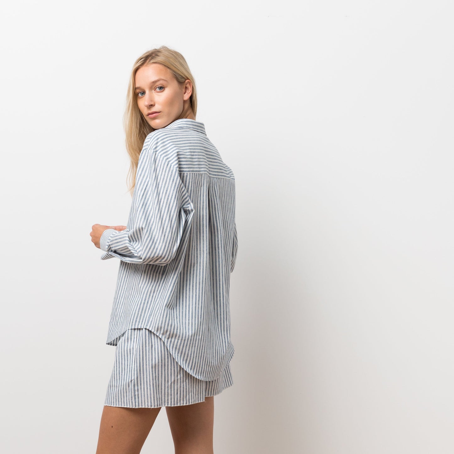Woman wearing striped shirt and shorts