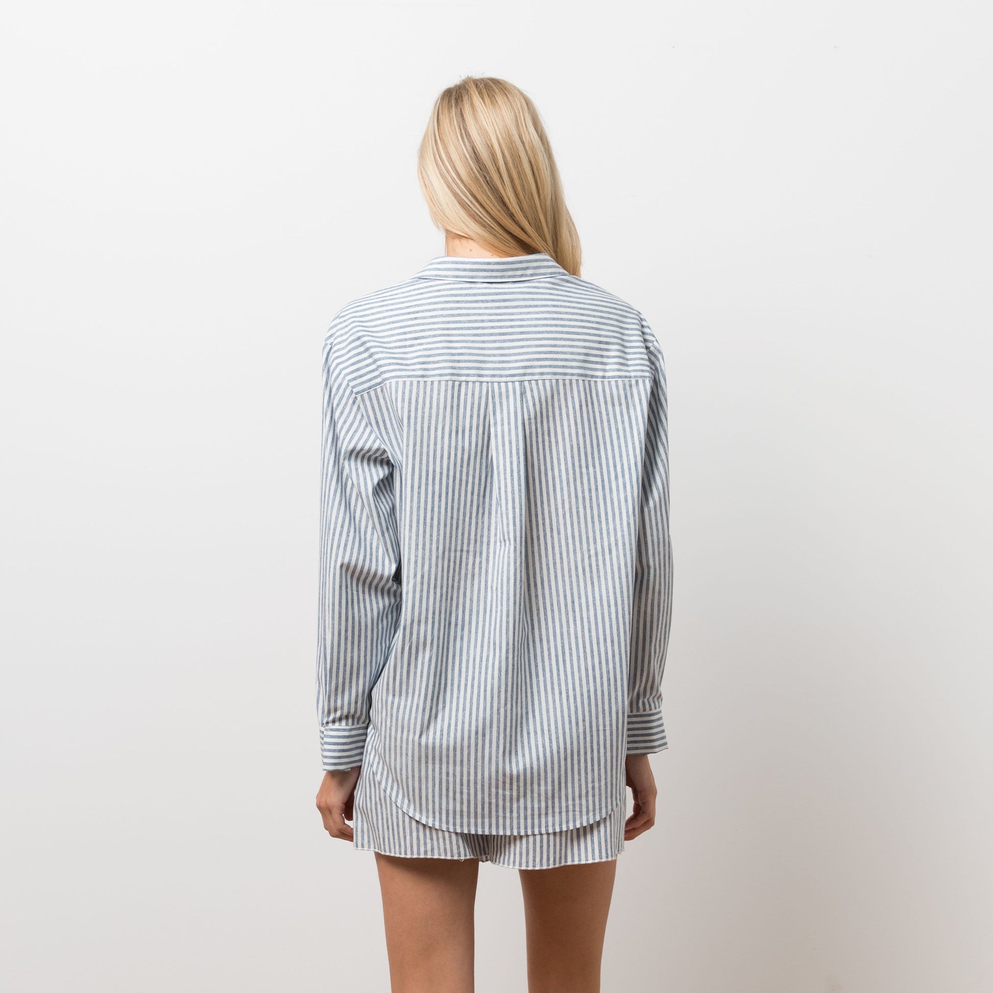 Woman wearing striped shirt and shorts