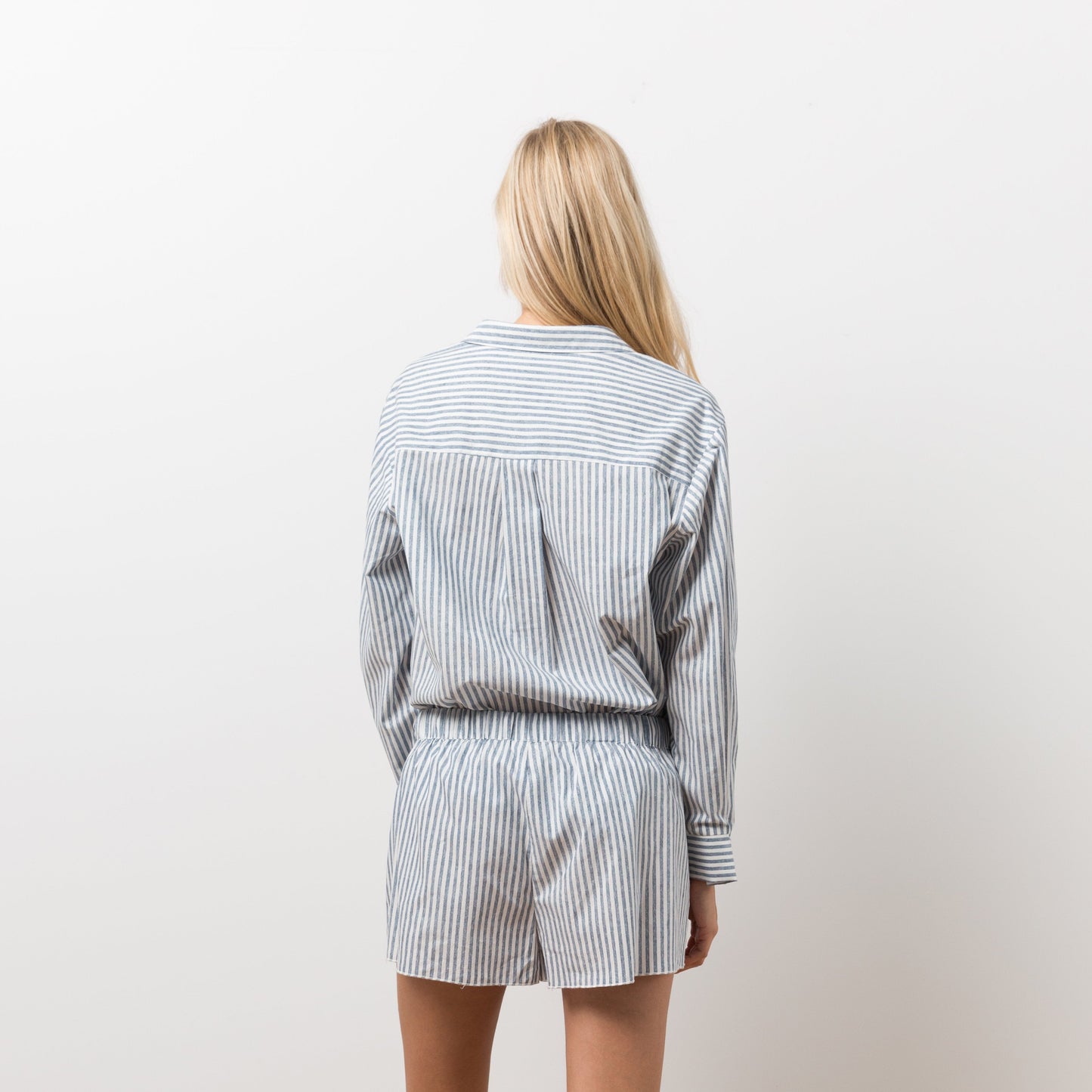 Woman wearing striped shirt and shorts