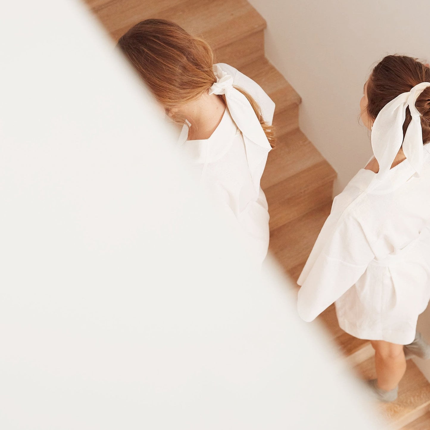 White scarves in two women's hair