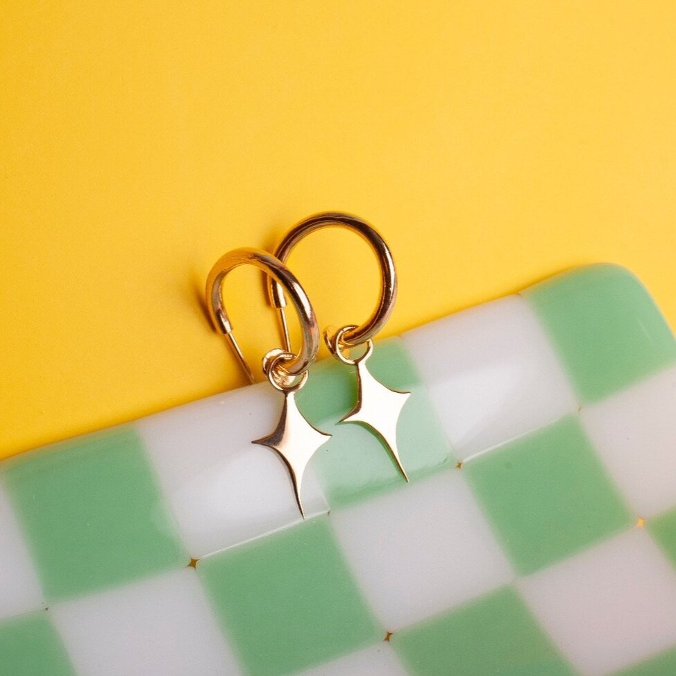 Small hoop earrings with a star shaped charm 