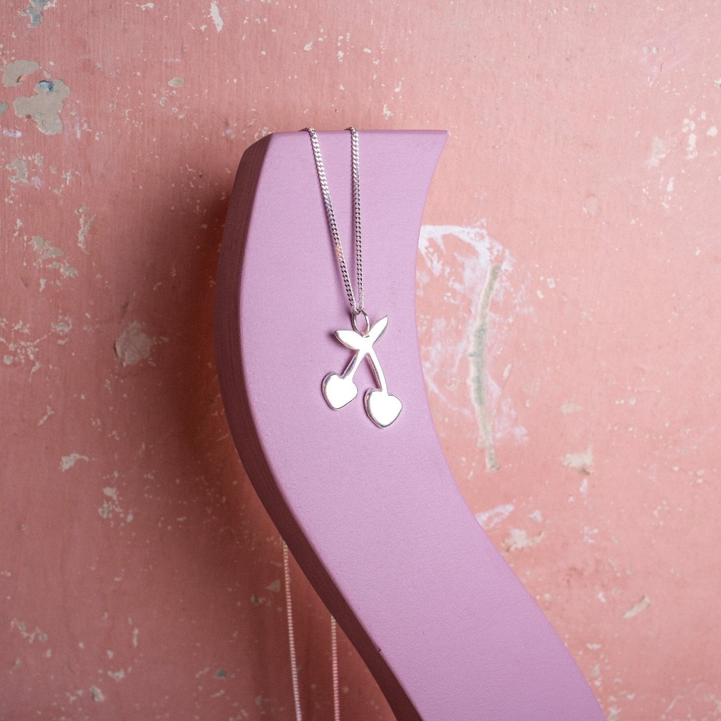 Silver pendant necklace with a cherry shaped charm