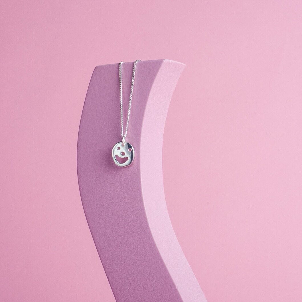 Close up of silver Smiley Necklace