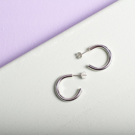 Close up of small silver hoop earrings