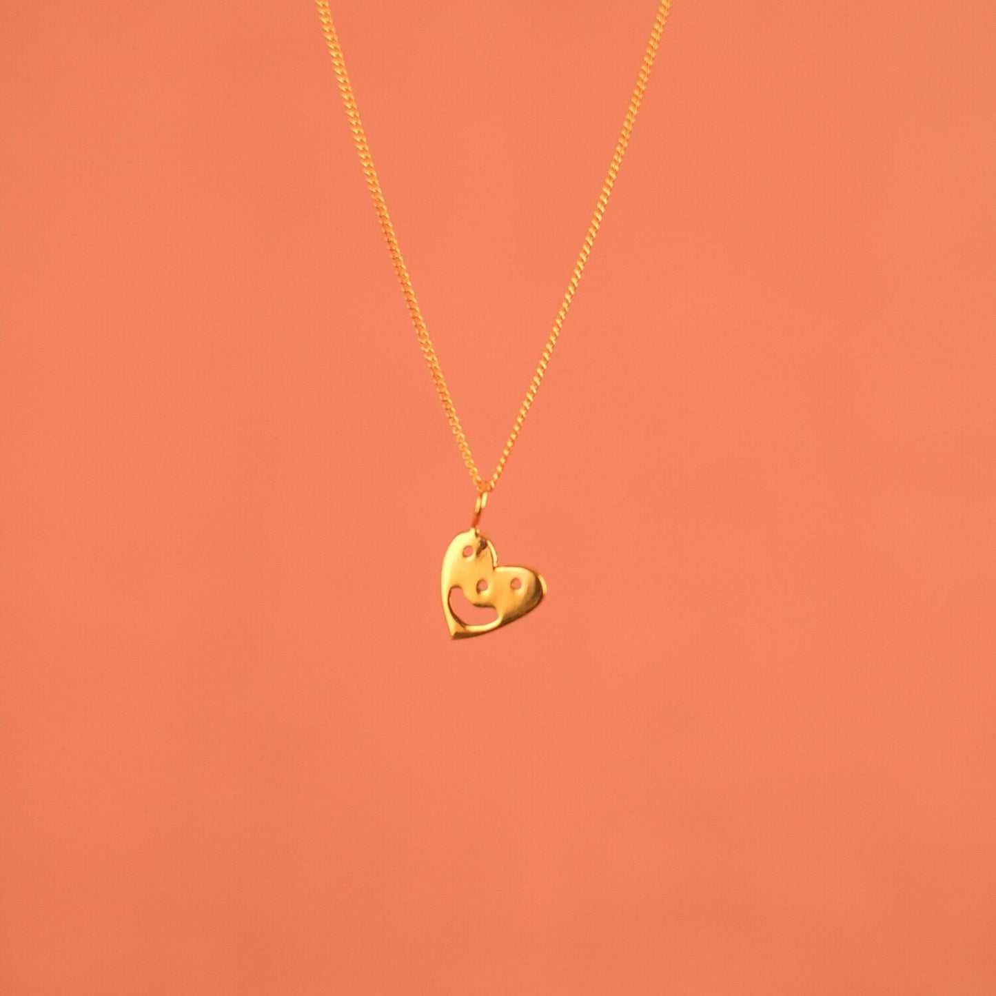 Pendant chain necklace with a smiling heart charm