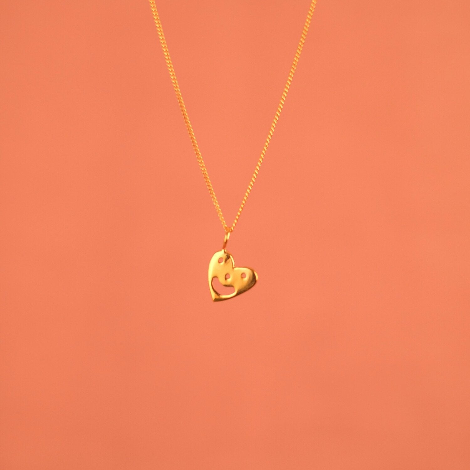 Pendant chain necklace with a smiling heart charm